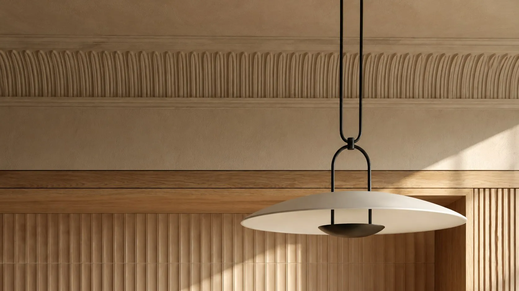 Carved cornice detail above fluted oak panelling with a pendant light