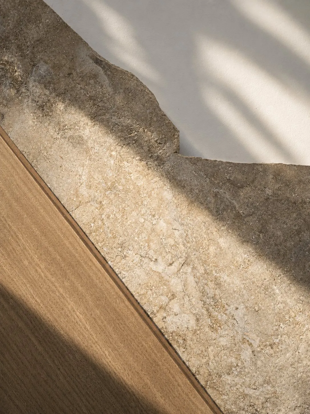 Natural stone and timber material palette showing earth and wood elements
